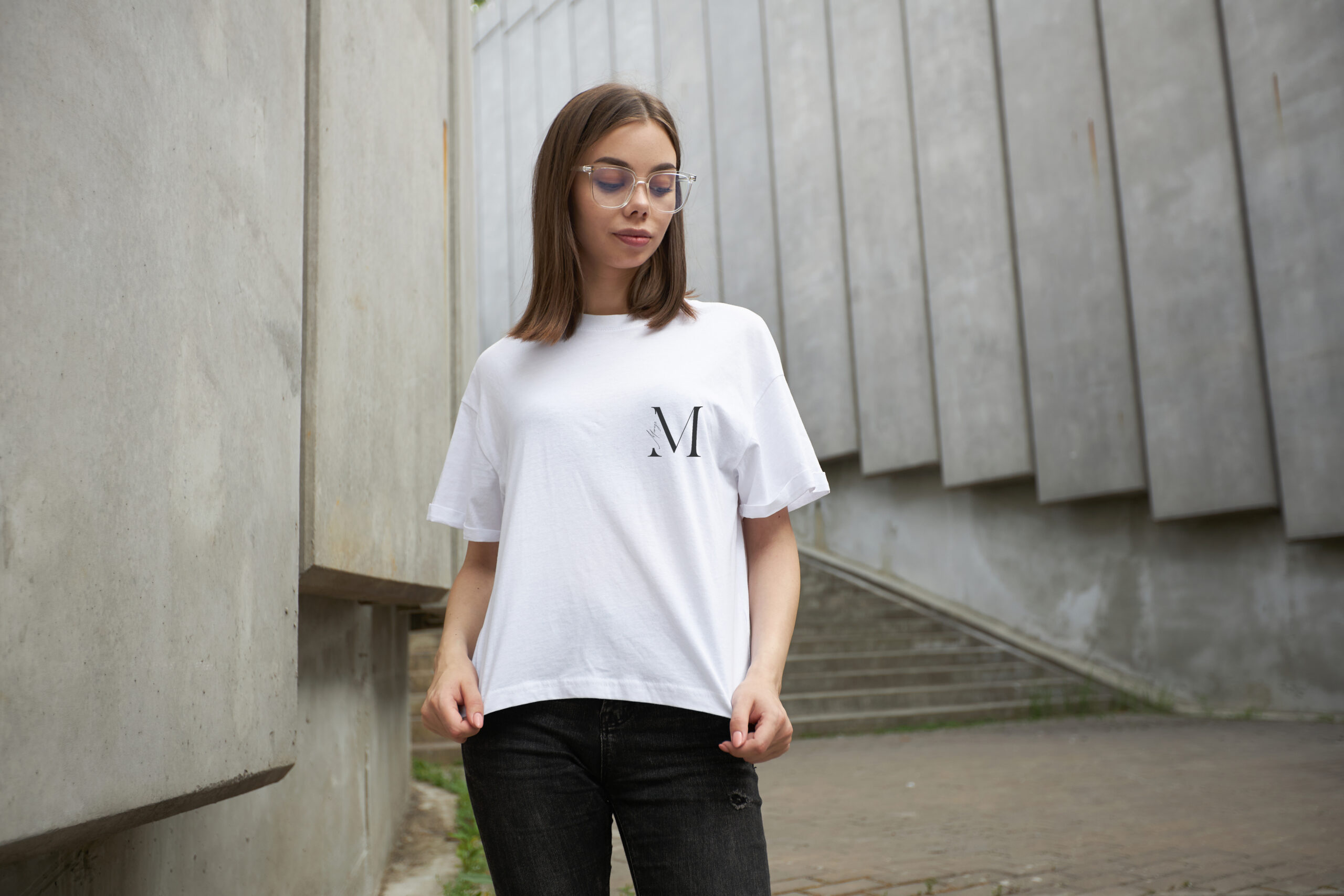 Girl or woman wearing white blank t-shirt with space for your logo, mock up or design in casual urban style